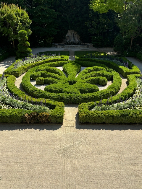 Beautifully designed formal garden with trimmed hedges.