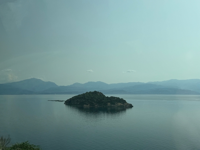 A small island surrounded by calm water.