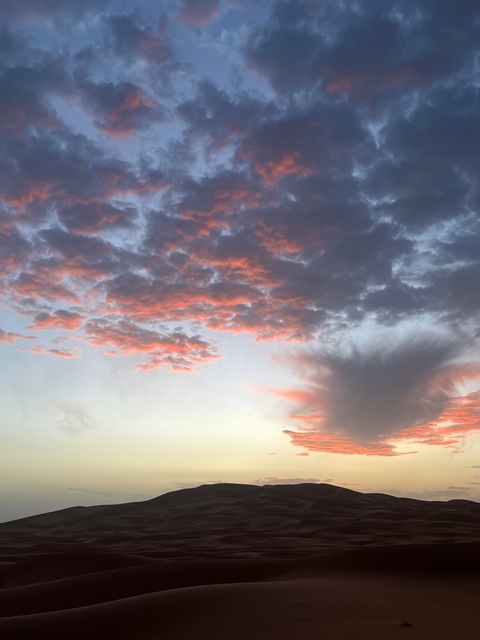 A colorful sunset with scattered clouds.