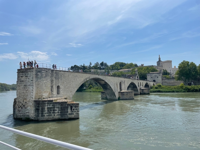 The Pont Saint-Bénézet bridge over the Rhone river with people.
