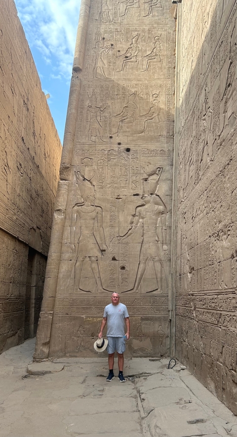 Hieroglyphics and carvings on ancient stone walls.