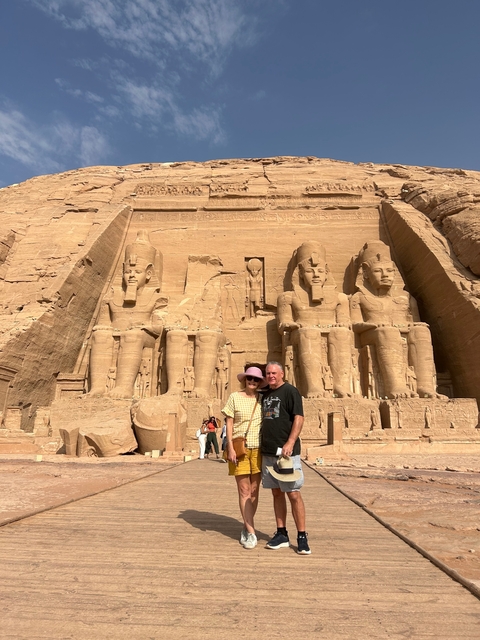       A couple in front of the Great Temple of Abu Simbel.
  