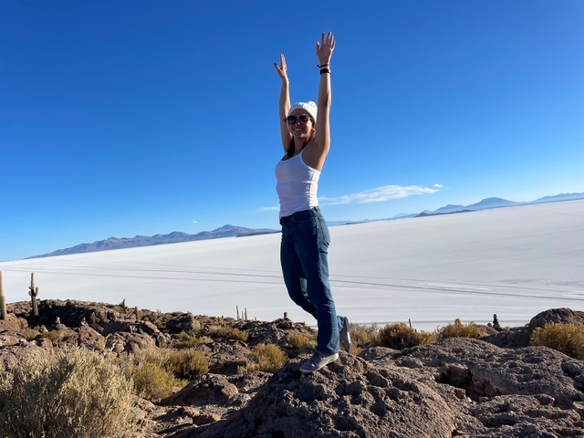 Woman posing in front of a vast salt flat.