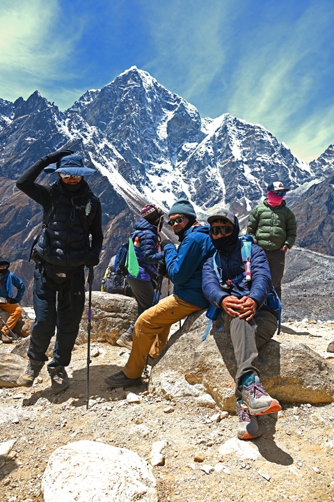       A group of people in winter clothing in a mountainous area.
  