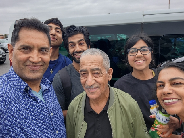 Group photo with a van in the background.