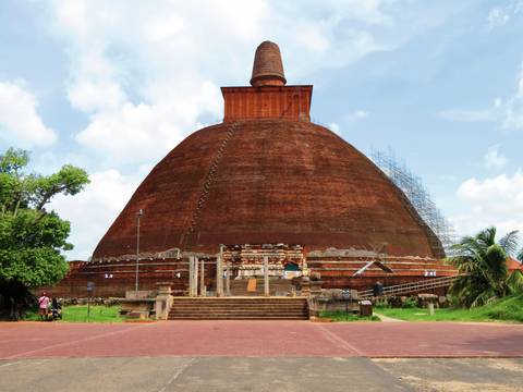 An ancient stupa with a large dome and intricate decorations.