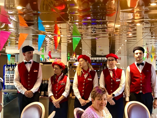 Staff dressed in uniforms on a cruise ship.