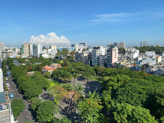       Cityscape with green parks and modern buildings.
  