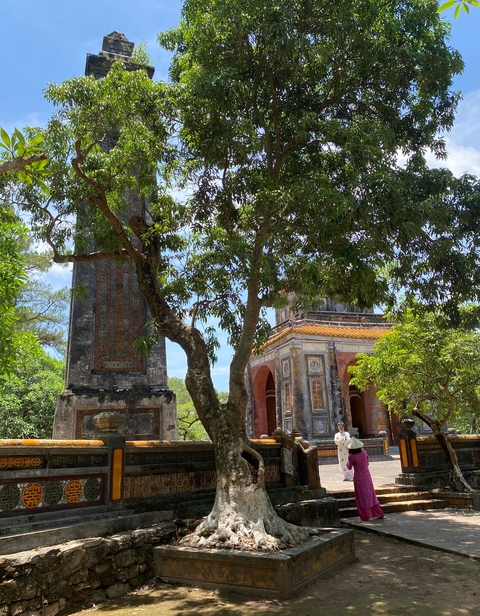       Temple structures surrounded by trees and gardens.
  