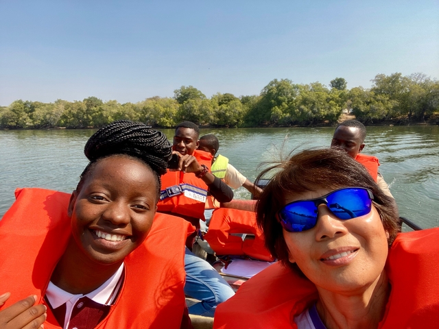 Group of people wearing life jackets in a boat.