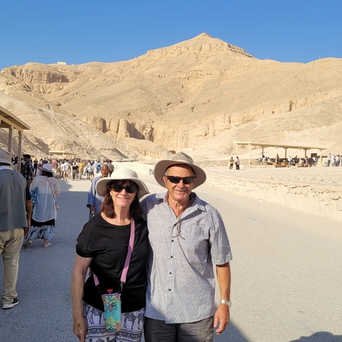 Couple posing in front of desert landscape.
