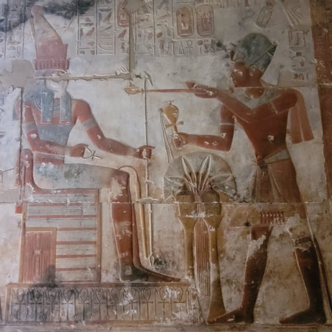 Ancient Egyptian mural with vibrant colors.