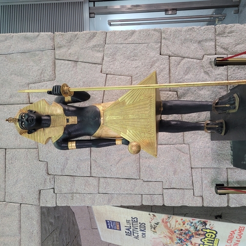 Egyptian statue in a museum setting.