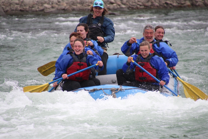 Group of people enjoying a white-water rafting adventure.