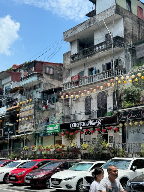 Colorful street with cafes and lanterns.