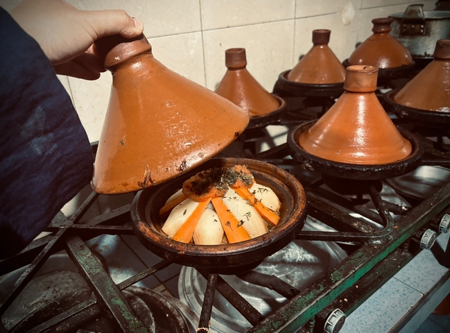 Traditional tagine dish being prepared.