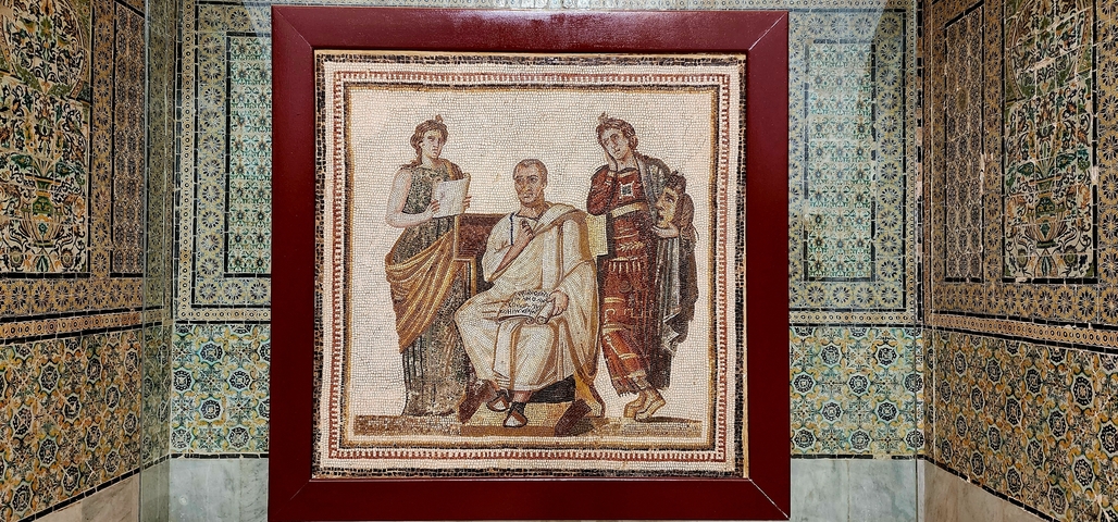 Framed mosaic in a decorative setting.