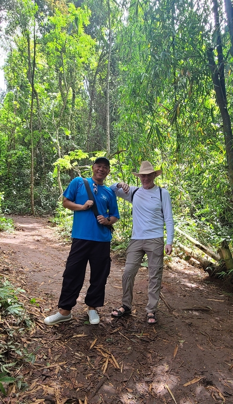 Two men posing on a jungle path.