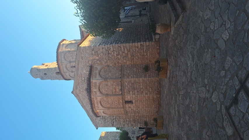       Stone church in a quaint setting.
  