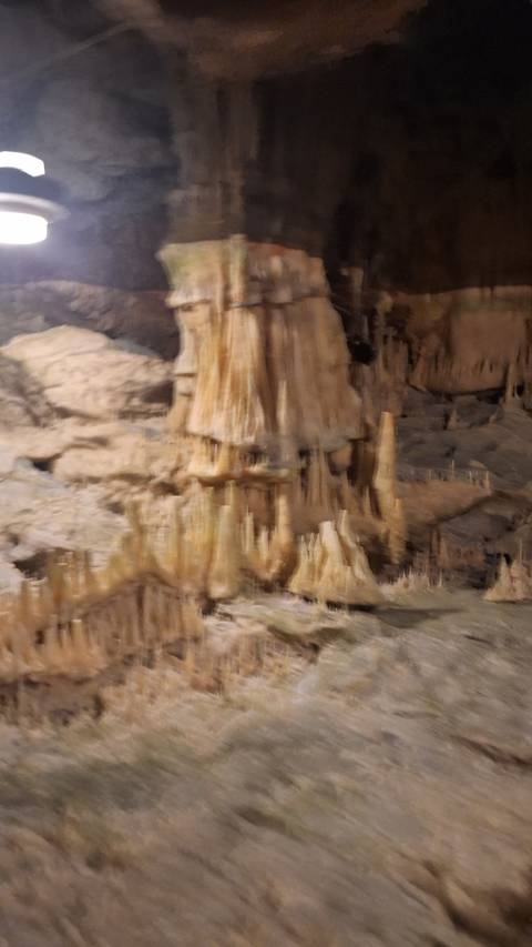       Blurry image of stalactites in a cave.
  
