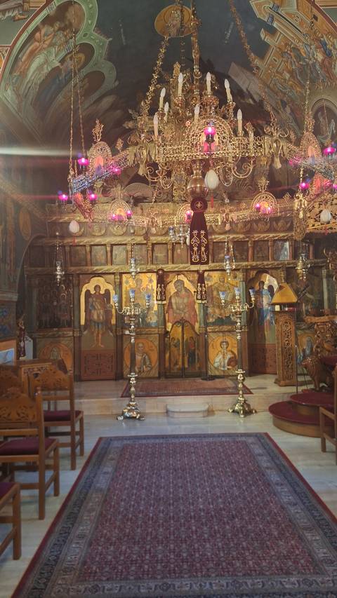       Interior of a traditional church with ornate icons.
  