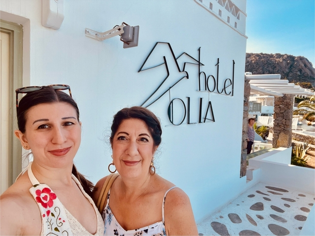       Two women posing in front of Hotel Olia.
  