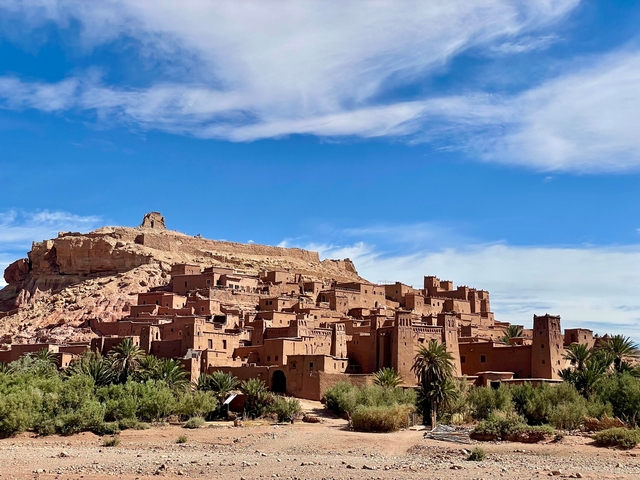 Historical fortified village with desert backdrop.