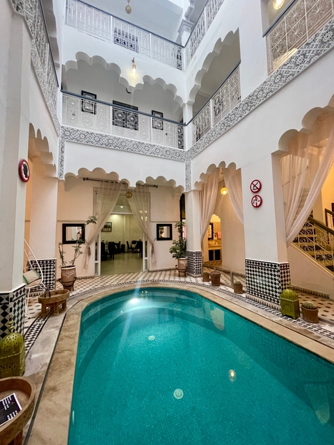 Traditional Moroccan riad courtyard with pool.