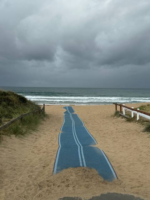 Beach view with a pathway leading to the ocean.