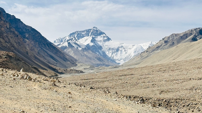 Vast mountainous landscape with snow-covered peaks.