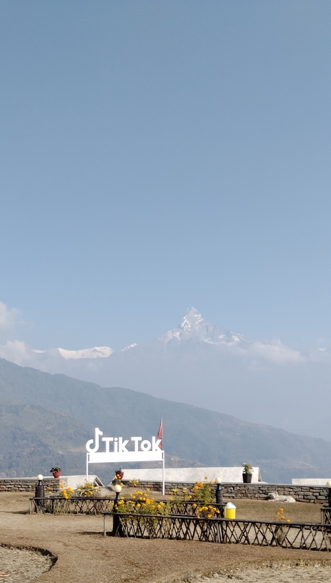       Snow-capped mountain peaks beneath a clear blue sky.
  