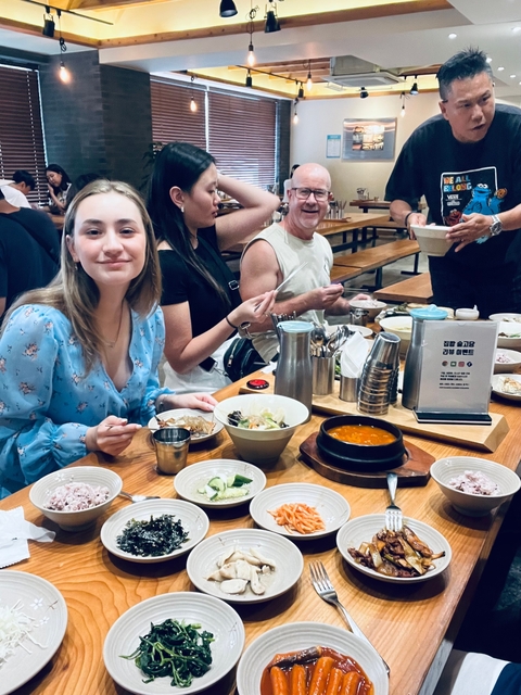 People dining in a Korean restaurant with traditional food.