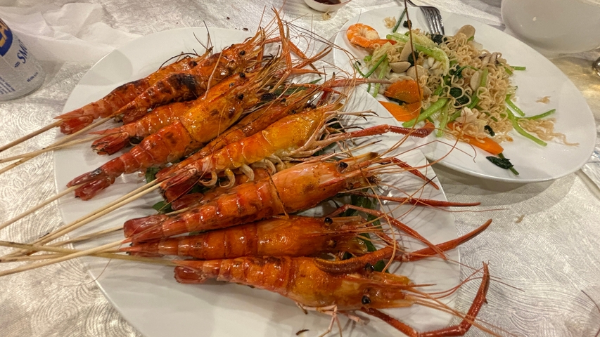 Plates of grilled prawns with salad.