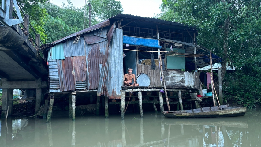 Old wooden house on stilts by the water.