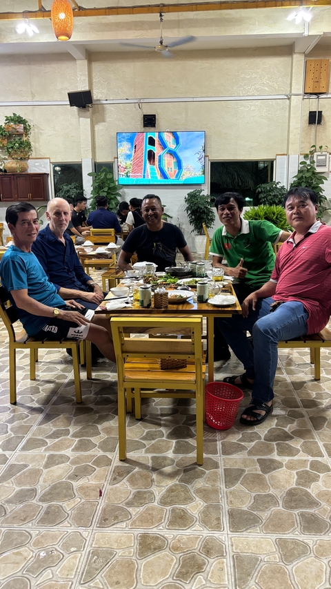 Group of friends dining outdoors at a restaurant.