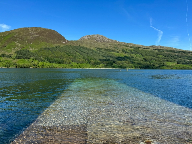 Beautiful lake with a mountainous background and clear water.