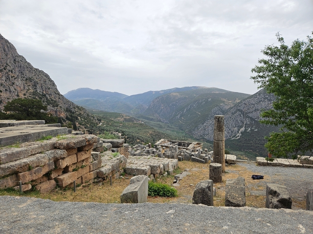       Ancient ruins with a mountainous landscape in the background.
  