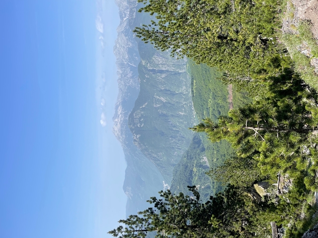       Mountain landscape with valley view and clear sky.
  