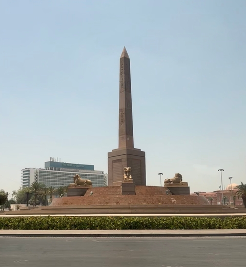Obelisk with two reclining sphinxes at its base.