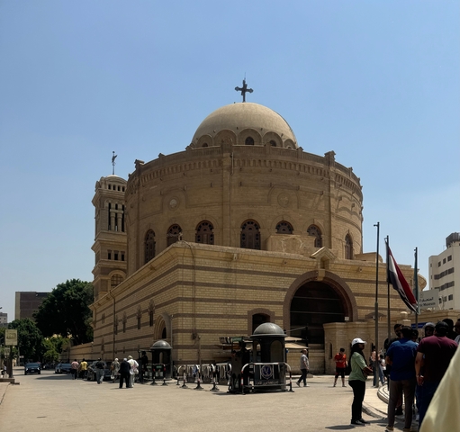       Dome-shaped church with a flag in the foreground.
  