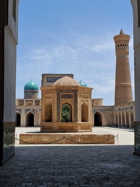       Beautiful mosque courtyard with blue domes and intricate architecture.
  