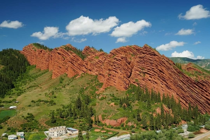       Dramatic red rock formations under a blue sky.
  