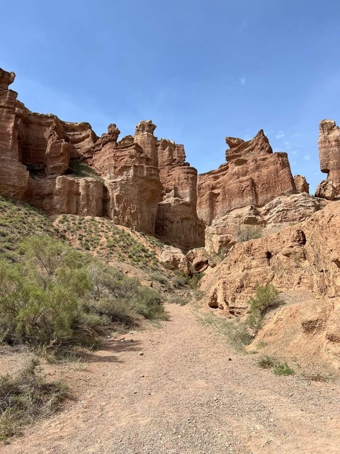       Canyon with rugged red rock formations.
  