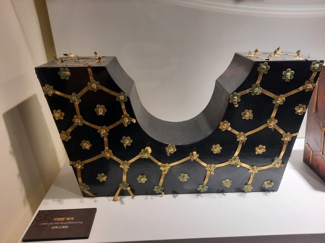 Decorative black and gold lacquered wooden artifact.