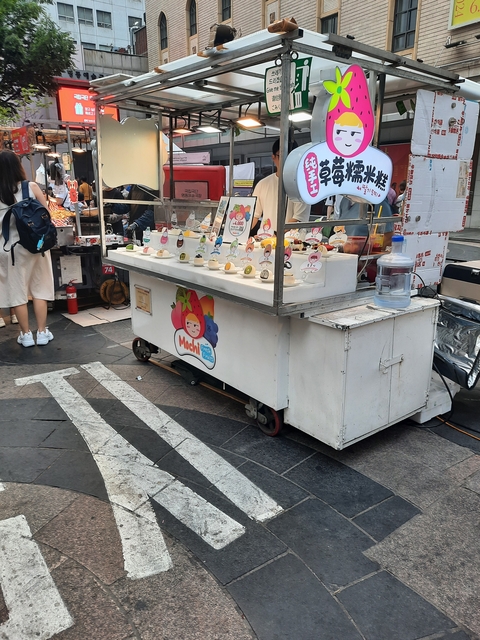 Street food cart selling ice cream and drinks.