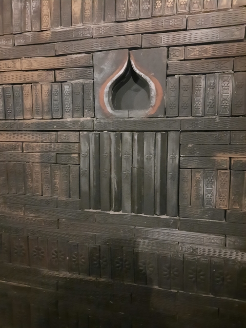       Close-up view of traditional wooden print blocks displayed on a wall.
  
