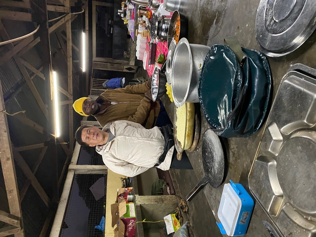 Cooking class setup with instructors and dishes.