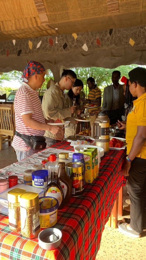 Buffet setup with people serving themselves.