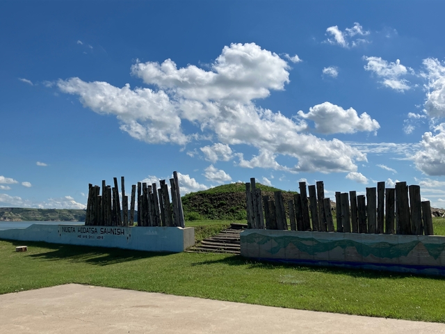 Wooden structure with clear blue sky and clouds.