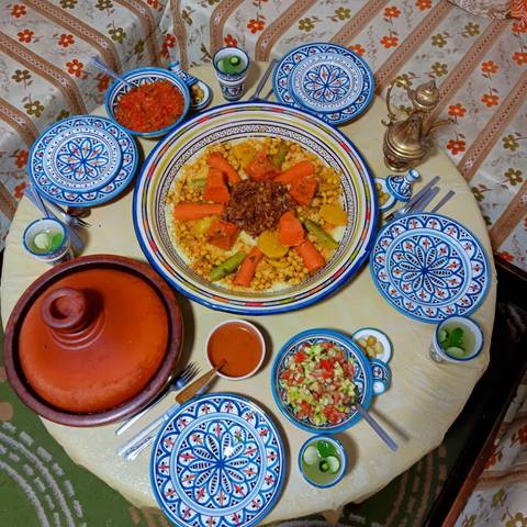 Traditional Moroccan meal served on a table with patterned dishes.